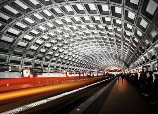 a train passing through a tunnel at a metro station