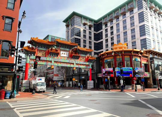 a busy city street with a large archway in the middle