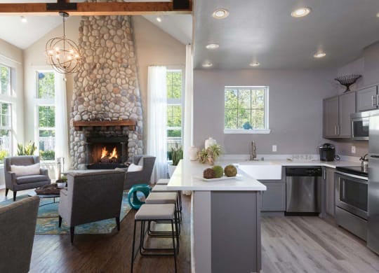 Common area with table chairs fireplace and kitchen area at Echo Ridge, Snoqualmie, WA