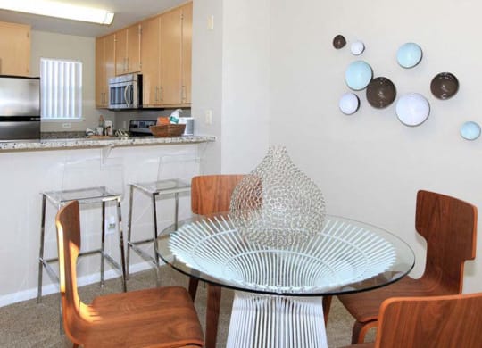 Dining room table with view of kitchen at The Enclave CA, San Jose, 95134
