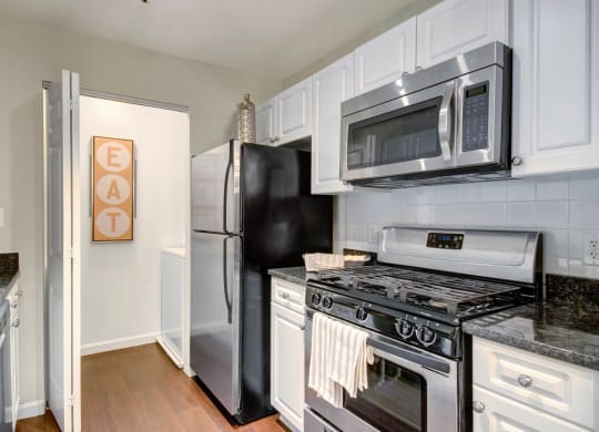 New Renovations, Upgraded Kitchens with Stainless Appliances, Washer Dryer & Modern White Cabinets at Ellington Metro West, Westborough, MA