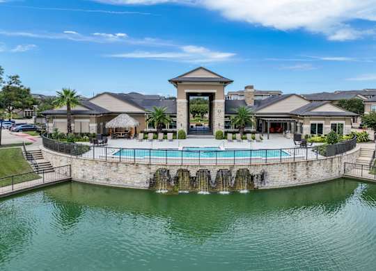 lakeside swimming pool at The Falls at Copper Lake Houston apartments