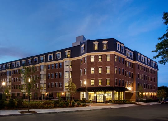 Exterior 5-Story Building at Dusk with Beautiful Controlled Access Entrance and Garage Parking Entrance at Gatehouse 75, Charlestown, Massachusetts