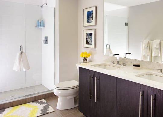 Spa Baths with Frameless Glass Shower, Beautiful Ebony Vanity with Dual Sinks, Large Mirrors and Hard Surface Flooring at Gatehouse 75, Charlestown, MA, 02129