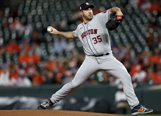 baseball player throws a pitch during a game
