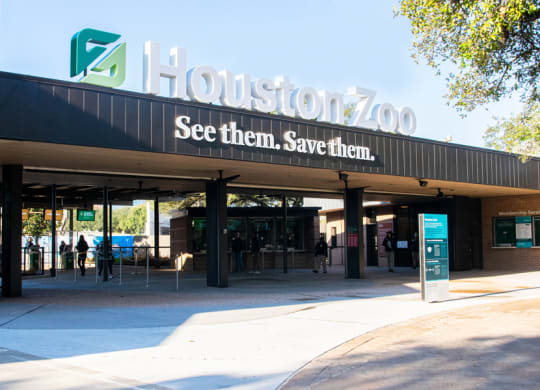 the entrance to the zoo with a sign on the building