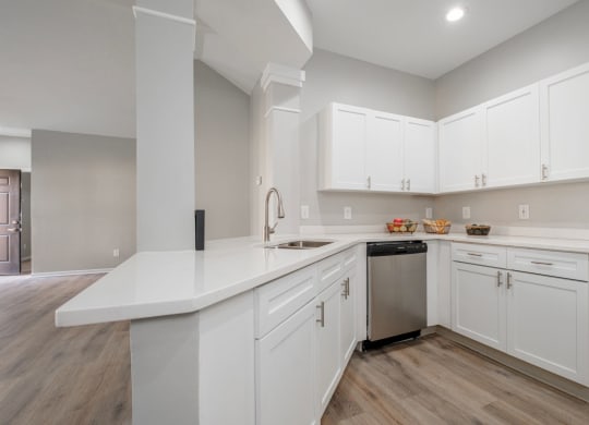 Kensington Grove apartments large white kitchen with white cabinets and a stainless steel dishwasher