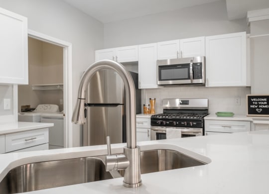 Kensington Grove apartments kitchen with white cabinets