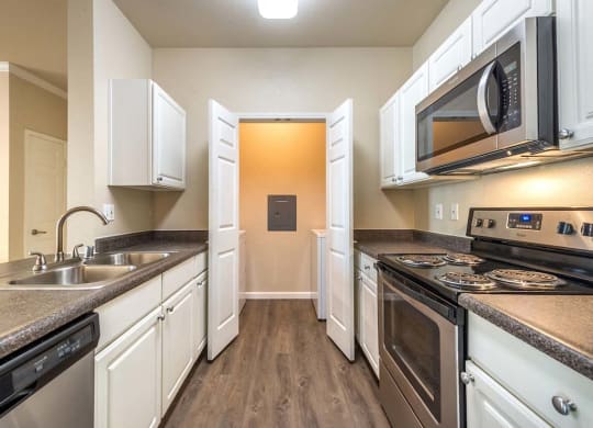 Kitchen with adjacent washer and dryer room