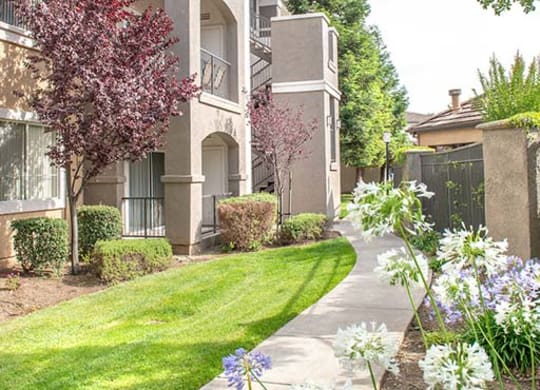 Grass lined walk way to apartment building