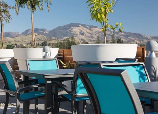 Outdoor common area with chairs and cafe tables at Lyric, Walnut Creek, 94596