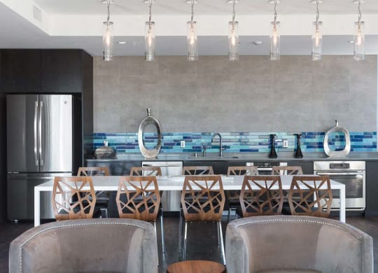 Common area with armchairs and kitchen area at Lyric, California