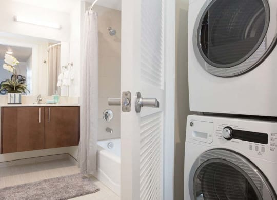 Bathroom with floating vanity and stacked washer dryer at Lyric, Walnut Creek, 94596