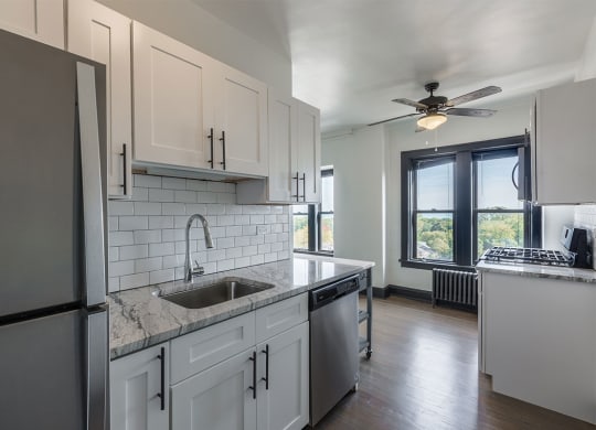 The Edison apartments kitchen with stainless appliances and tile backsplash
