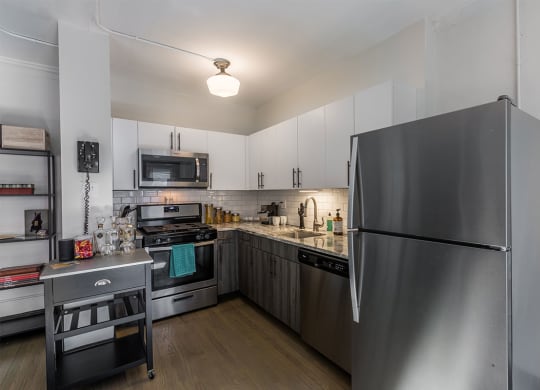 The Edison apartments kitchen with stainless appliances and white cabinetry