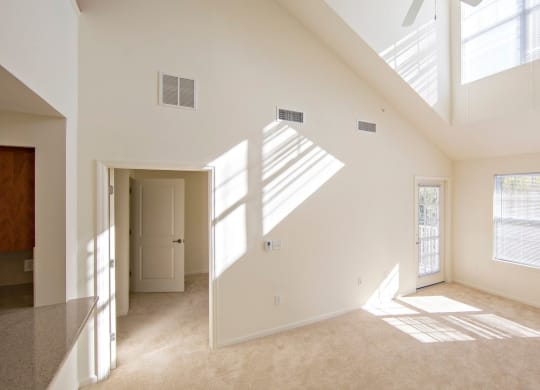 the living room and dining room of a two floor unit at Reveal Hackensack apartments