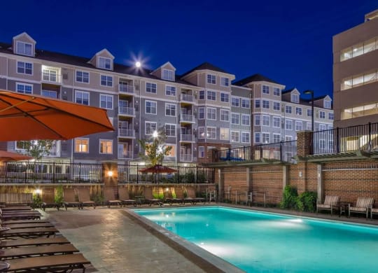 a pool area at Reveal Hackensack apartments at night