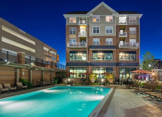 a pool at Reveal Hackensack apartments in Hackensack New Jersey at night