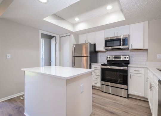 Perimeter Lakes apartments kitchen with white cabinets and stainless appliances