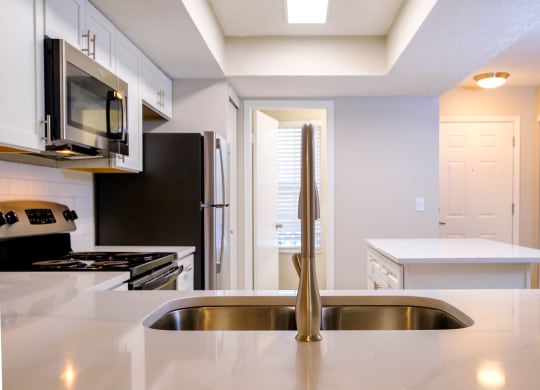 a kitchen with a sink and a refrigerator