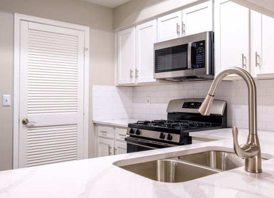 a kitchen with white cabinets
