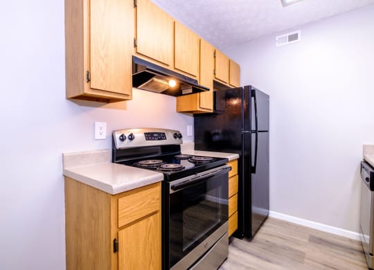a kitchen with wooden cabinets