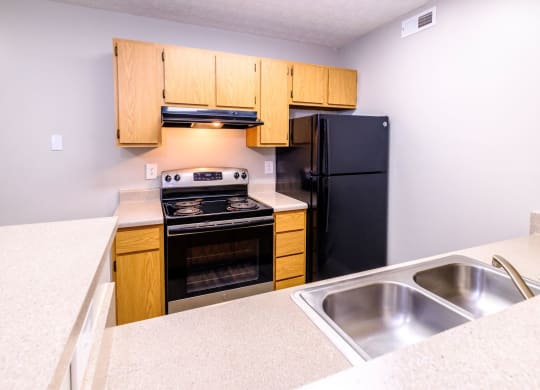 a kitchen with wooden cabinets