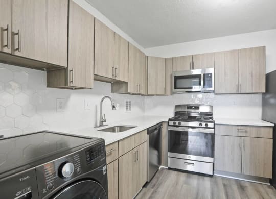 Skyline Towers apartments kitchen with stainless steel appliances and wooden cabinets