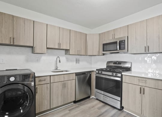 Skyline Towers apartments kitchen with wood cabinets and stainless kitchen appliances