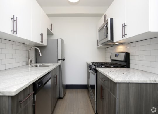 The Edison apartments modern kitchen with custom cabinetry and stainless appliances