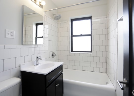 The Edison apartments bathroom with tile backsplash