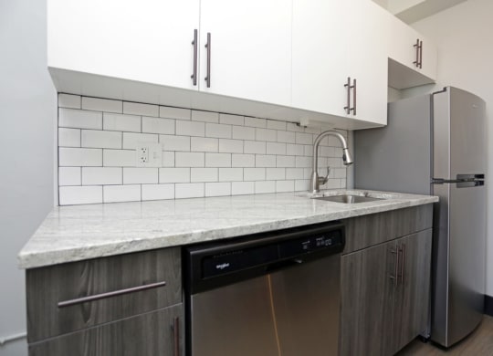 The Edison apartments kitchen with custom cabinetry and stainless appliances