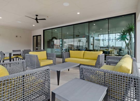 Living room with yellow sofa at  Reveal Skyline at La Cantera, San Antonio, TX