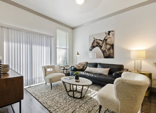 Living room with sofa and wall frame at Reveal at Bayside, Texas