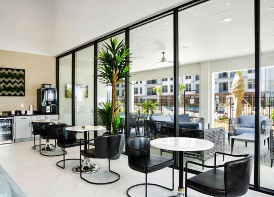 clubhouse dining with table and black chairs at Reveal at Bayside, Rowlett, 75088