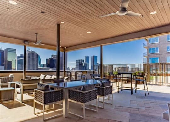 a n outdoor lounging area with Dallas skyline views at The Gabriella apartments