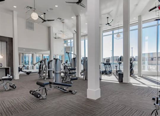 a gym with weights and cardio equipment at The Gabriella apartments