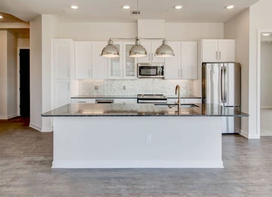 spacious kitchen with a white cabinets at The Gabriella apartments