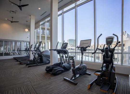 the fitness center with cardio machines at The Gabriella apartments