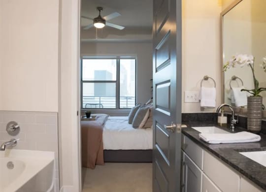 a bathroom with a view of a bedroom at The Gabriella apartments