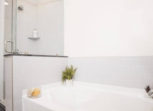a luxury bathroom with a soaking tub and separate shower at The Gabriella apartments