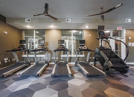 fitness center with cardio equipment at Aspire at 610 apartments