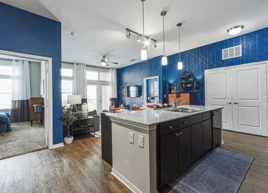 Open concept kitchen with designer lighting at Aspire at 610 apartments in Houston, TX