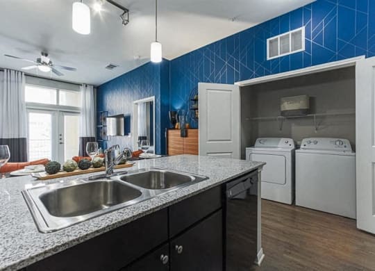 Kitchen with custom cabinetry and granite countertops at Aspire at 610 apartments