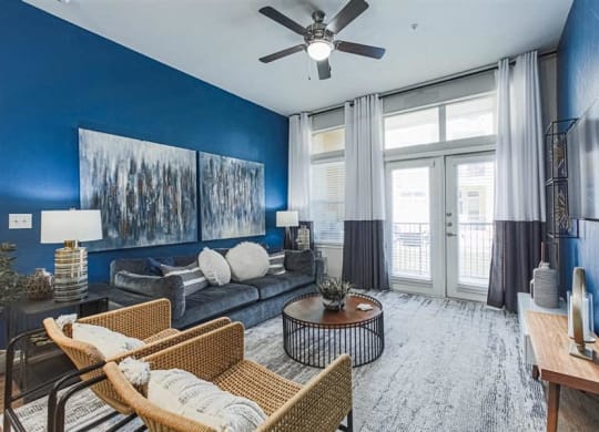 Spacious living room with ceiling fain and expansive windows at Aspire at 610 apartments