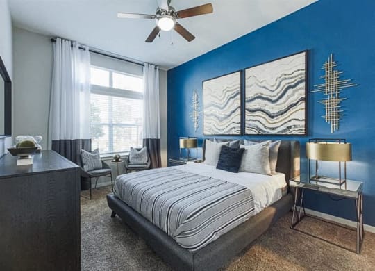 Spacious bedroom with ceiling fan at Aspire at 610 apartments