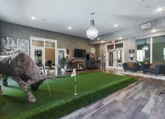 indoor putting green at Aspire at 610 apartments