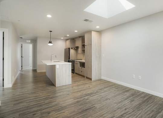 A spacious kitchen with wooden floors and a skylight at The Avenue Lofts Golden Apartments, Golden
