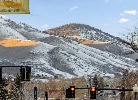 A mountain with a sign that says VisitGolden.com at The Avenue Lofts Golden Apartments, Golden 80401