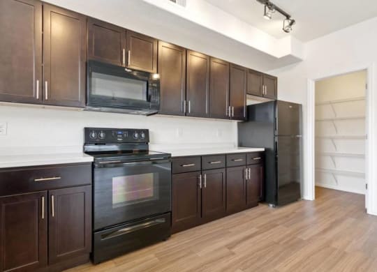 Fully Equipped Kitchen Includes Frost-Free Refrigerator, Electric Range, & Dishwasher at Belle Creek Commons, Henderson, CO
